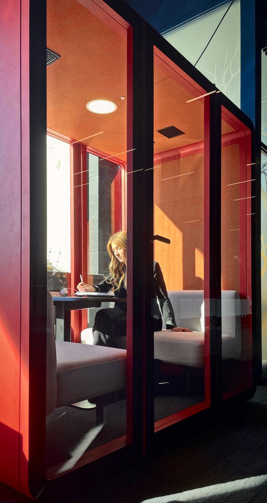 Working at the meeting table inside an Aria Tavola.
